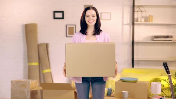 Smiling Girl Putting Package Smiling Camera New Home — Stock Video