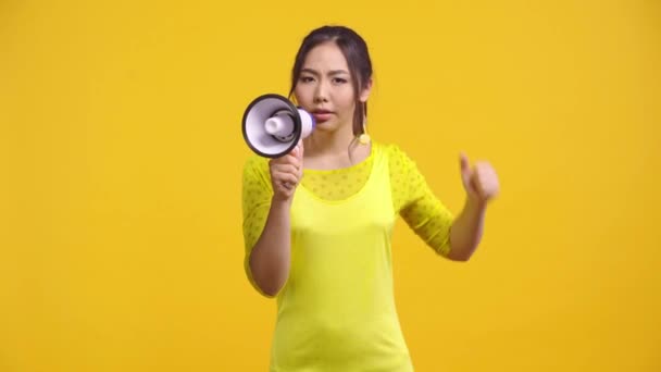 Displeased Asian Girl Screaming Holding Megaphone Isolated Yellow — Stock Video