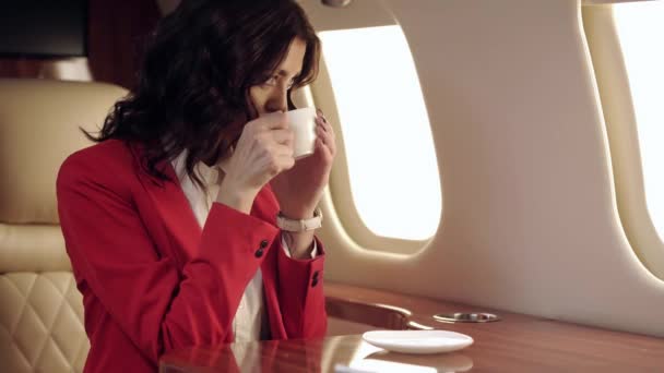 Happy Businesswoman Drinking Coffee While Traveling Plane — Stock Video