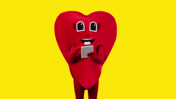 Person Red Heart Costume Holding Digital Tablet Isolated Yellow — Stock Video