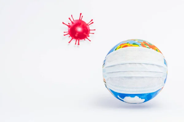 Globe in protective medical mask near drawn virus on white — Stock Photo