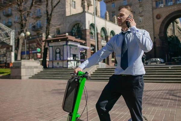 Businessman With Smartphone, Backpack And Scooter
