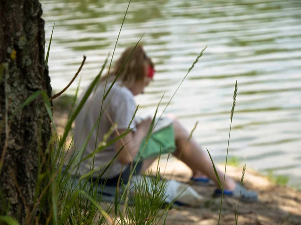 Girl Writer Draws School Park Under A Big Tree Near Lake.