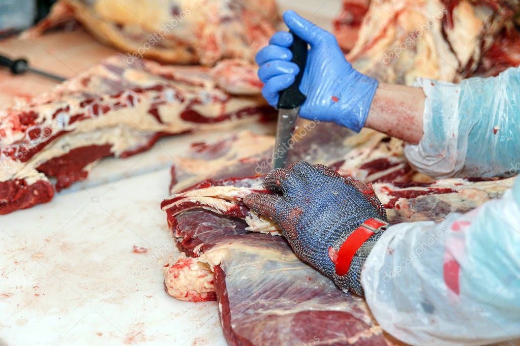 Cutting meat slaughterhouse workers in a meat factory.