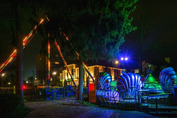 Gece cityscape ve bir eğlence parkı aydınlatma