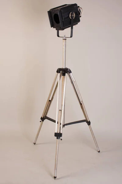 Old theater lamp on a tripod on a gray background — Stock Photo, Image