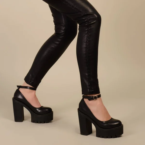 Long legs in skinny leather pants and high heels shoes — Stock Photo, Image