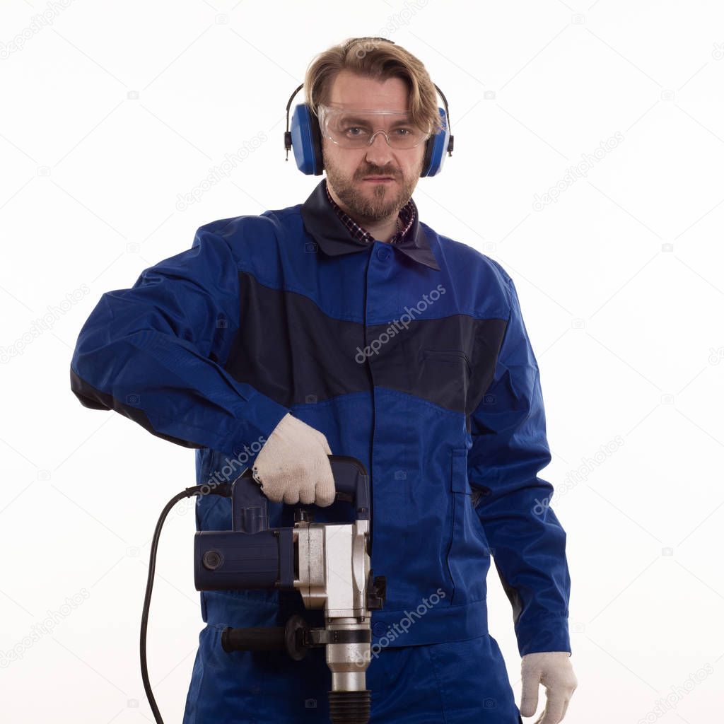 Construction worker stands leaning on the puncher on a white background