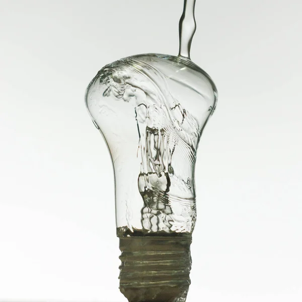 Light bulb made of water splashes — Stock Photo, Image