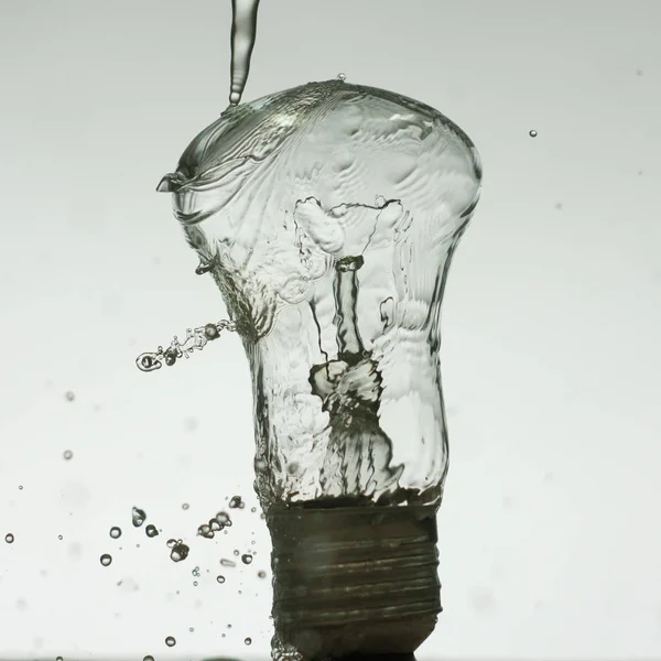 Light bulb made of water splashes — Stock Photo, Image