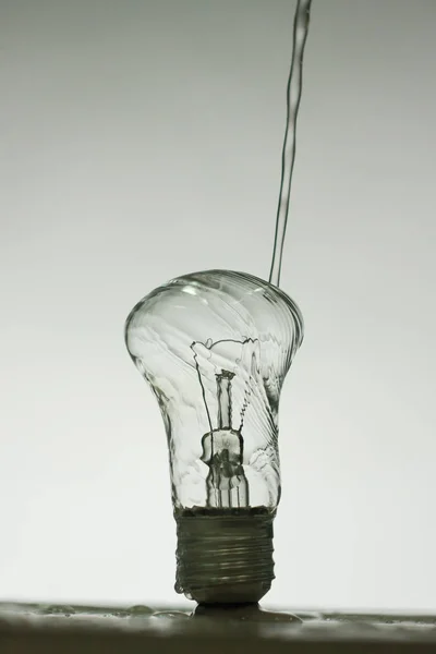Light bulb made of water splashes — Stock Photo, Image