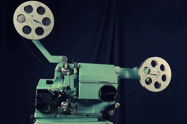 Old film projector on a black background