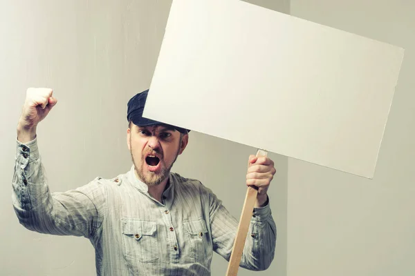 Angry protesting worker with blank protest sign.