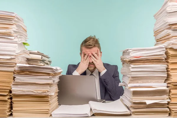 Close-up image of a stressful businessman tired from his work on the foreground - image