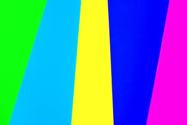 Vibrant colored rubber mats layered vertically to make a rainbow color background.