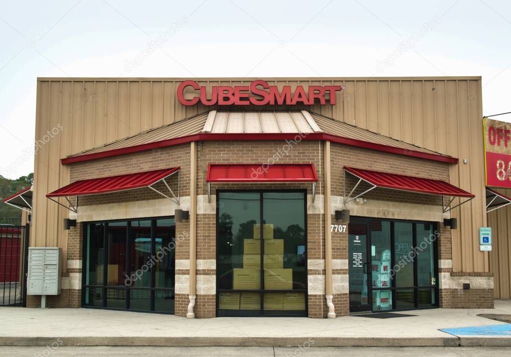 Humble, Texas/USA 01/01/2020: Cube Smart business exterior in Humble, TX. Self-storage facility chain founded in 2004. Metal storefront with red awnings and cardboard boxes visible inside facility.