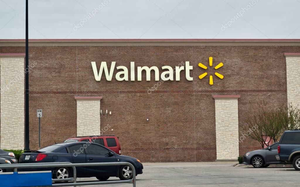 Humble, Texas/USA 01/01/2020: Walmart Supercenter store exterior in Humble, TX. Vehicles in parking lot. Basket return in the foreground. Worlds largest company by revenue. Founded in 1962.