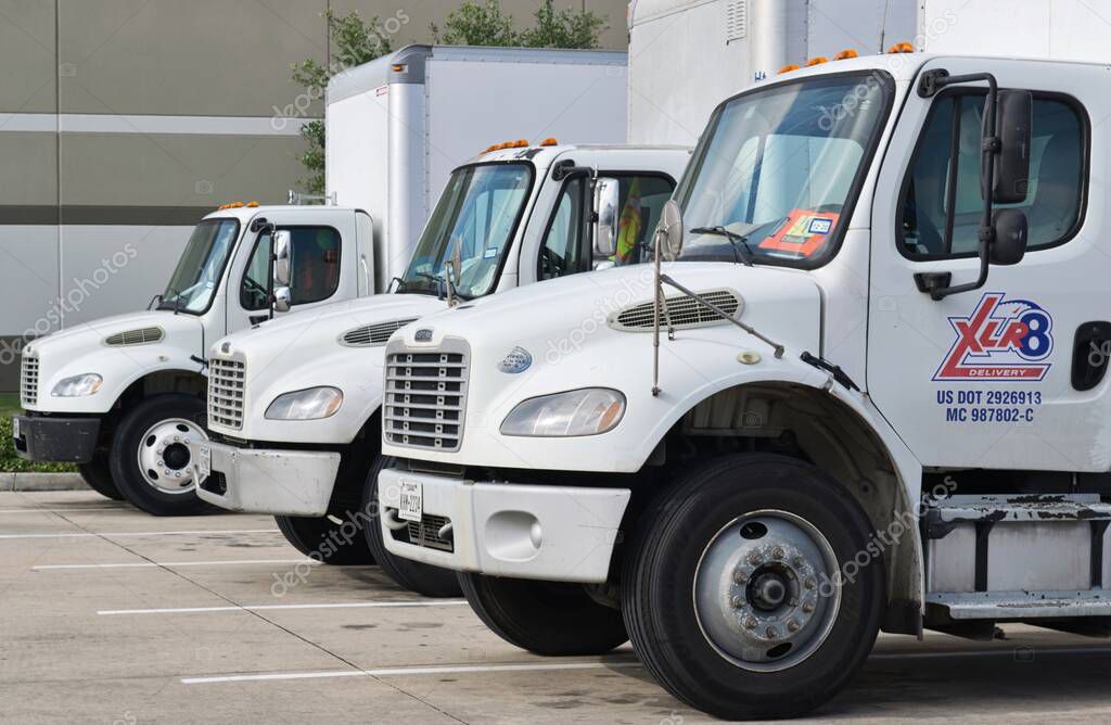 Houston, Texas/USA 04/19/2020: XLR8 Delivery fleet trucks lined up with focus on foreground. Texas transport company established in 2017 and owned by Gulf Coast Crating.