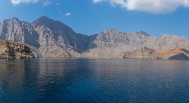Spectacular panorama of the fjords and rocky mountains and blue waters of Khasab, Musandam, Oman in the Middle East near the Strait of Hormuz. clipart