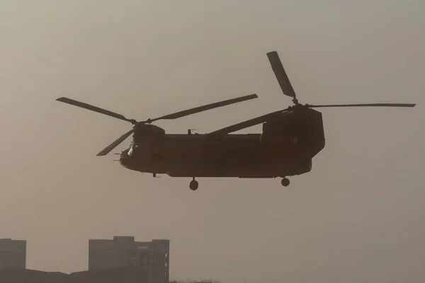 Military combat and war with helicopter taking off in the chaos