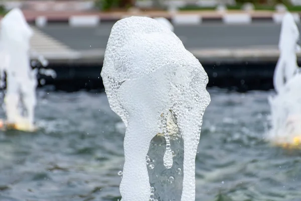 Water fountain close up spray of refreshing, cool, water droplet design in a fountain at a park.