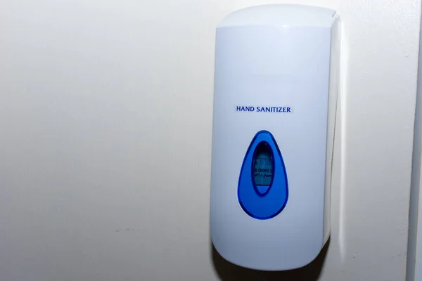 Hand sanitizer dispenser on a wall to protect against illness, bacteria and sickness. Cleanliness and flu concepts.