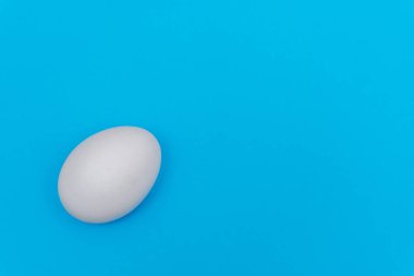 Paskalya bayramı dairesi beyaz yumurtayla kaplıydı. Fotokopi alanı olan parlak mavi renkli bir arka planı vardı..