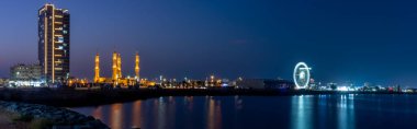 Night panorama in Ras al Khaimah, United Arab Emirates looking at the Sheikh`s Zayed`s Mosque ferris wheel and corniche area. Long exposure.