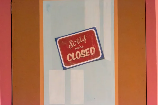 Sorry we\'re closed sign on painted pastel door. Shut down, closed, business problems, COVID-19 concepts.