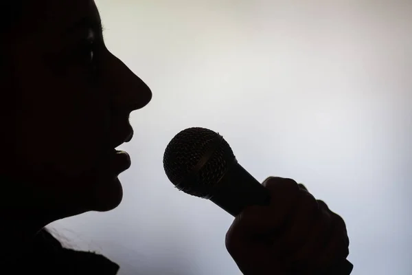 Žena zpěv na mikrofon — Stock fotografie