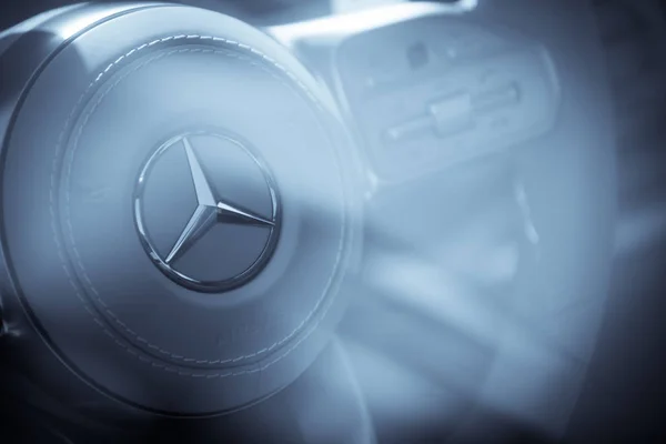 Mercedes Benz logo on a car steering wheel — Stock Photo, Image