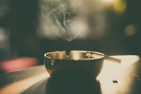 Burning cigarette in an ashtray — Stock Photo, Image