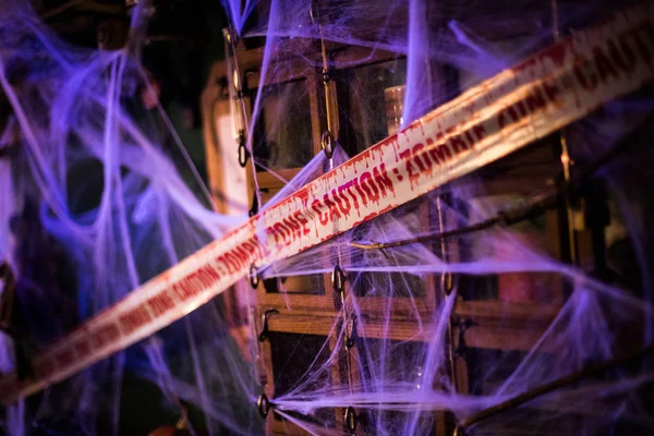 Zombie zone ribbon and spider webs — 스톡 사진