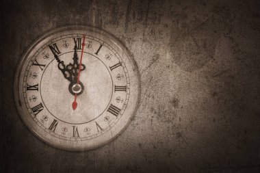Kahverengi duvarda sol tarafında asılı duvar saati