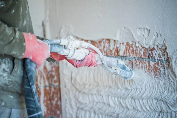 Plastering with a plastering pump Royalty Free Stock Images