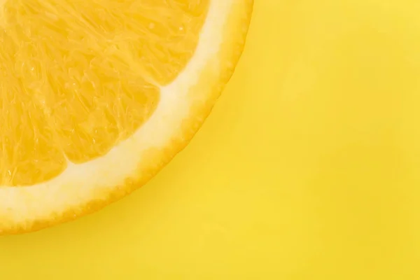 Juicy slice of lemon on a yellow background — Stock Photo, Image