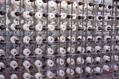 factory housing powered spinning or weaving machinery for the production of yarn clipart