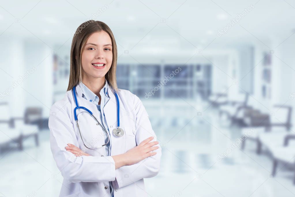 Young female doctor standing and smiling on hospital