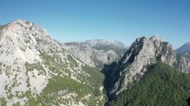 4K aerial view of mountain and forest with a open sky
