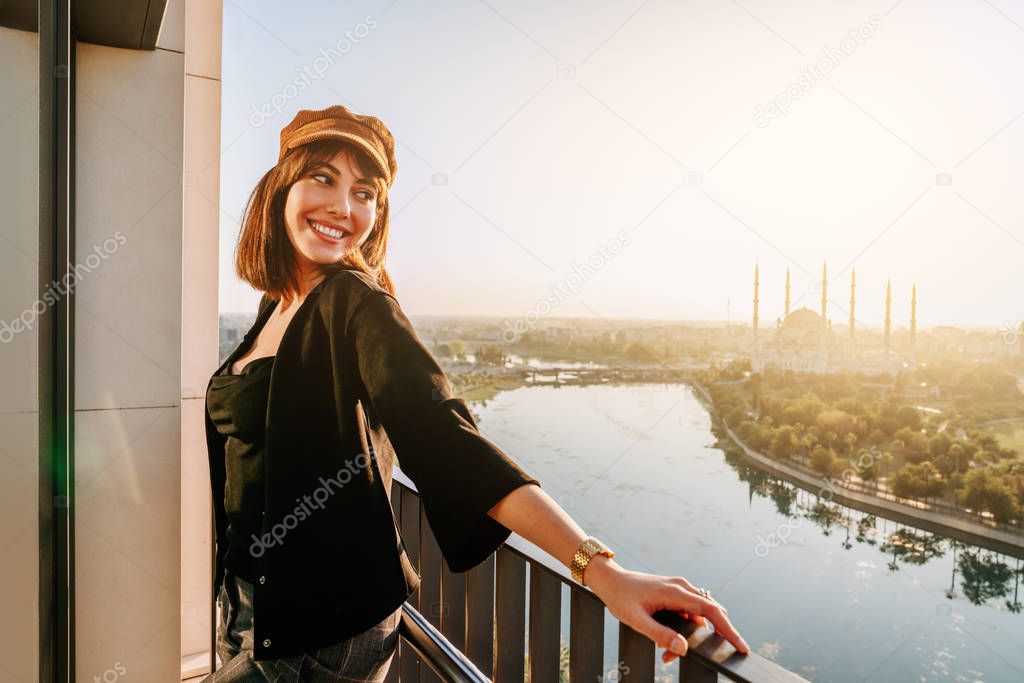 Young and beautiful woman with city and river landscape