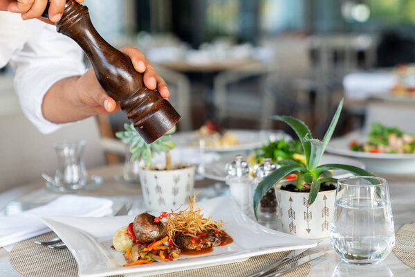 A delicious roasted beef with garnish is served in a elegance restaurant or hotel