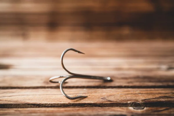 Big size three hooks for fishing on wooden table — Stock Photo, Image