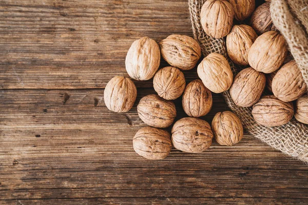 Close up top view of walnuts on a wooden table. Healthy life concept. — Stock Photo, Image