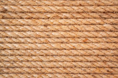 Kahverengi kıvrılmış halat. Kahverengi ve sarı ipli arka plan. Arkaplan için ip deseni.