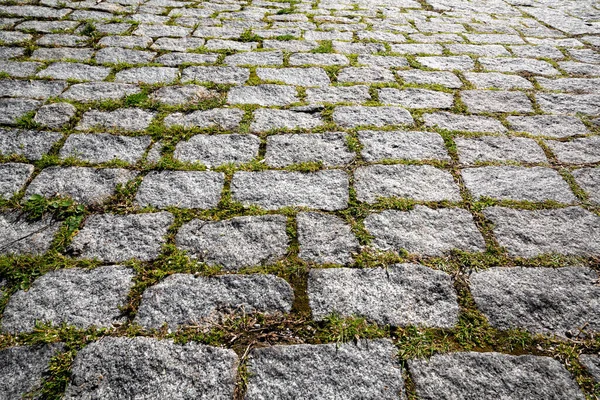 Gray cobble stone walkway or square. Pavement texture.