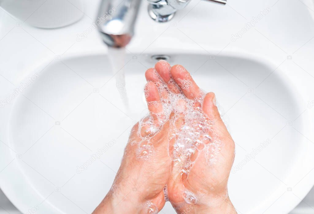 Personal hygiene, cleaning hands with soap often on faucet to protect from virus.