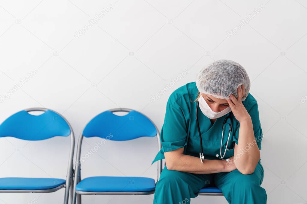 Woman doctor is sitting and has, worry, frustration, tiredness and exhausting deep feelings.