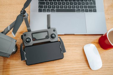 Ahşap arka planda veri transferi için profesyonel dron ekipmanı ve elektronik aksesuarlar..