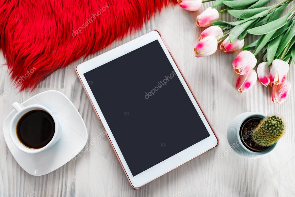 Tablet on a nice decorated white wooden table background. Styled design photography. Textures and mockup concept.