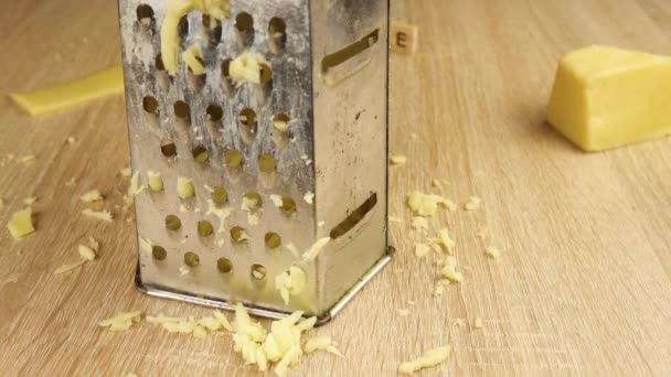Rough rubbing cheese on a grater — Stock Video